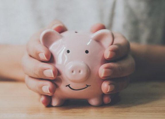 Close up of someone holding their piggy bank