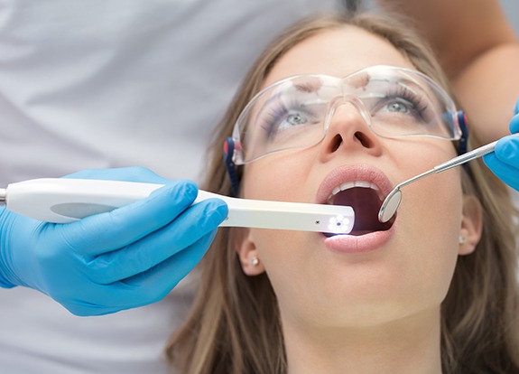 Dentist performing a dental exam with intraoral camera