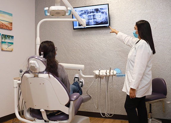 Doctor Heliben Desai showing a patient their digital dental x rays